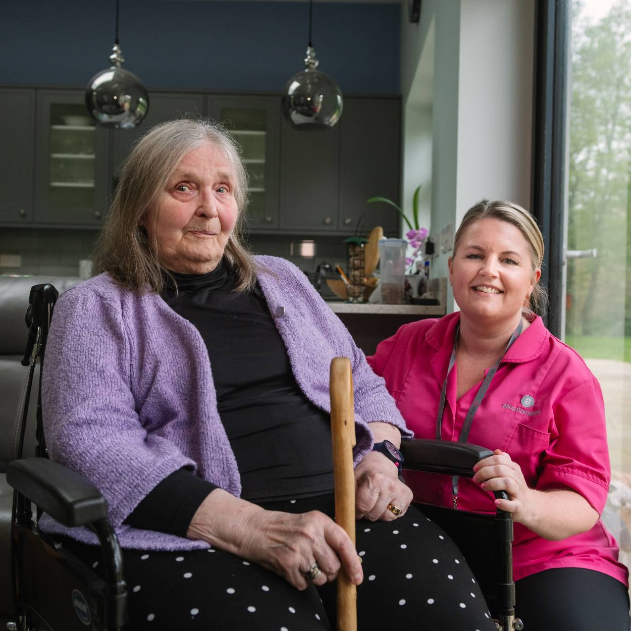Lady with care assistant job smiling with a client